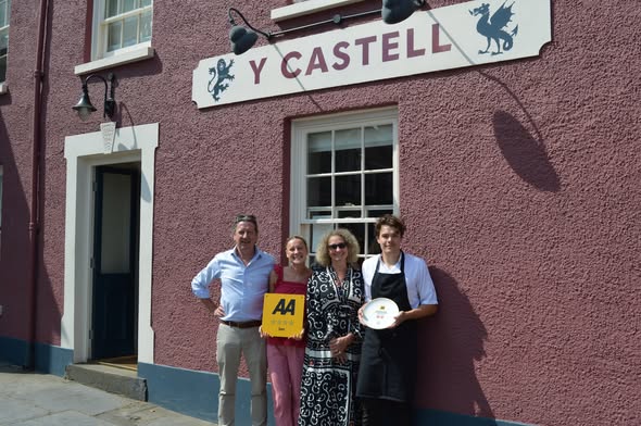 Owners Fiona Evans and Jonathon Wilkins with the Y Castell team and their AA awards outside the inn in Llangadog