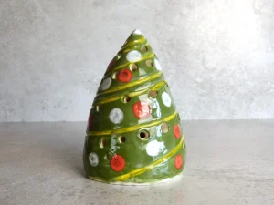 Handmade green ceramic Christmas tree lantern decorated with red and white baubles
