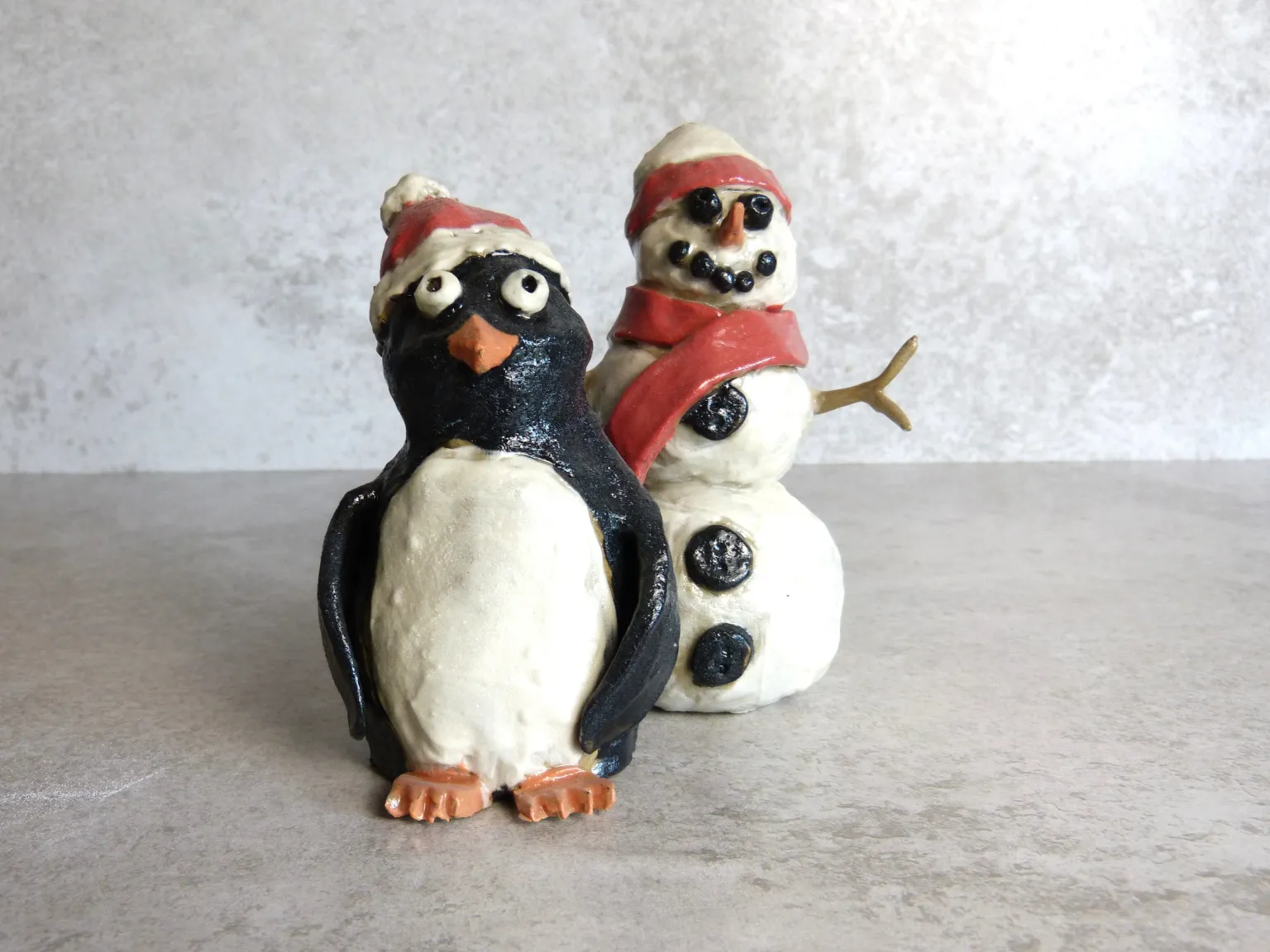 Handmade ceramic penguin and snowman Christmas figurines
