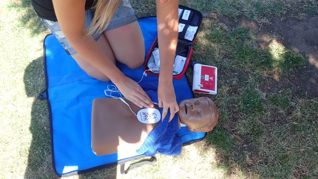 Outdoor first aid training with a defibrillator practice unit