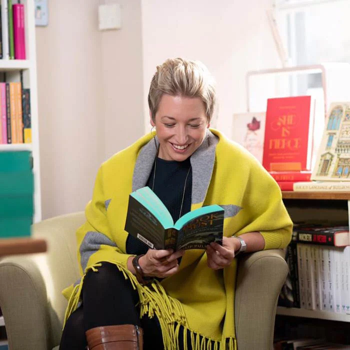 A visitor reading among the books at Book-ish