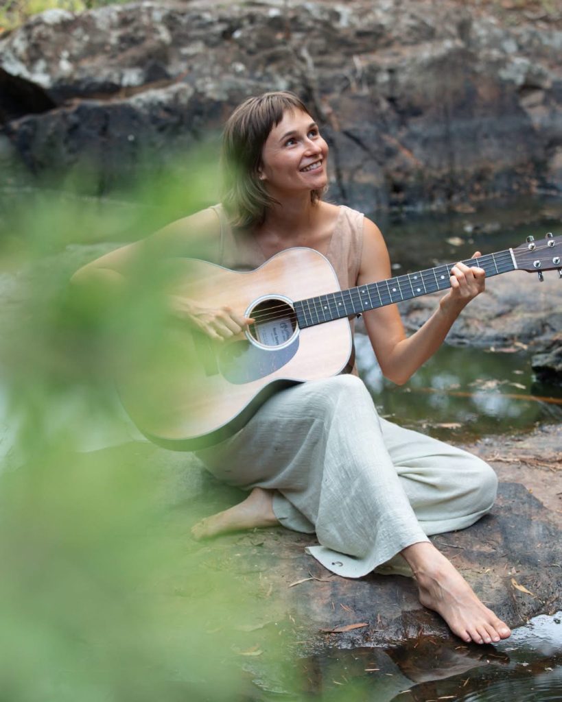 Australian singer-songwriter Isabel Rumble with her guitar