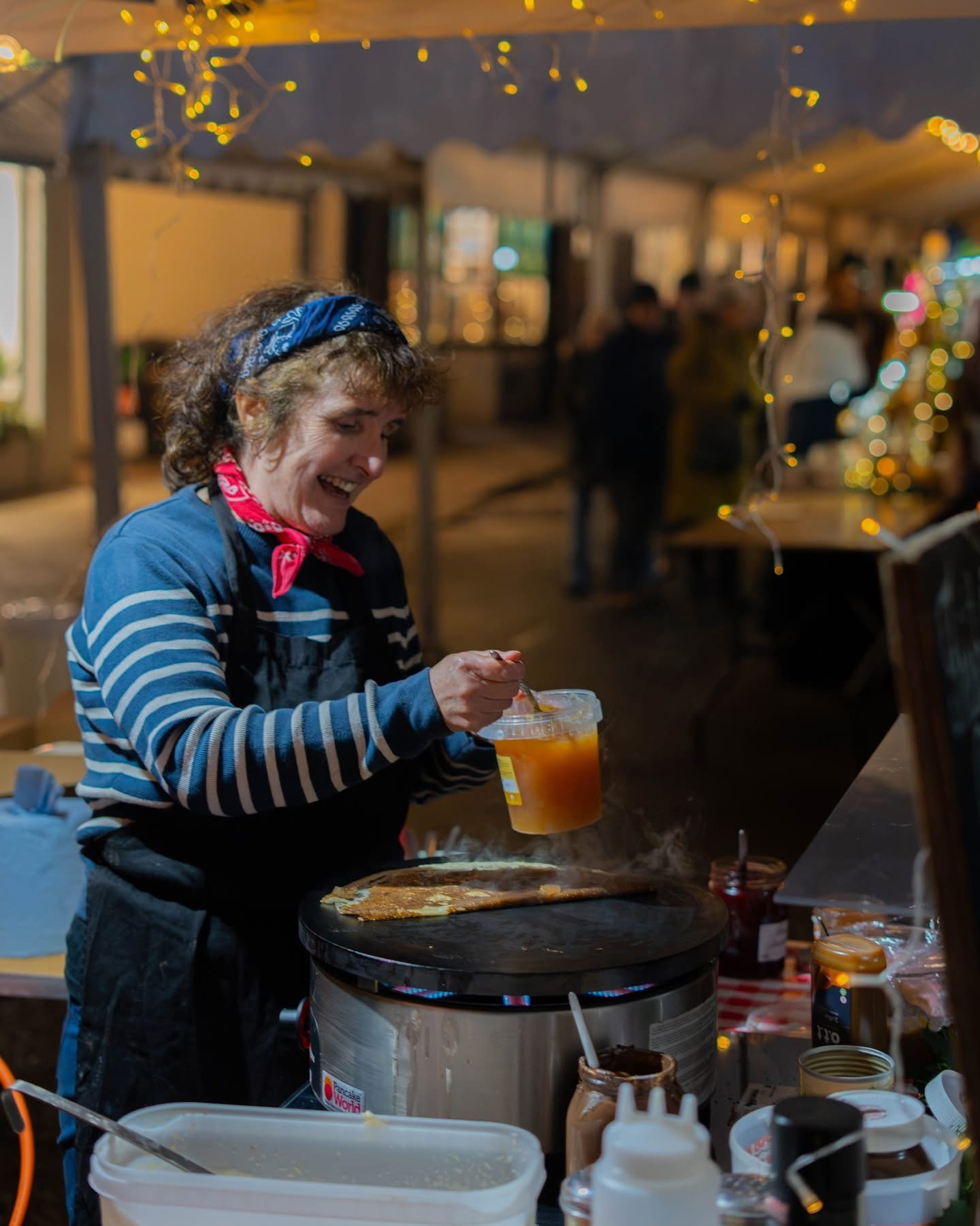 A shopper browsing an outdoor market stall in Crickhowell