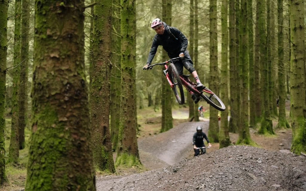Mountain biker airborne on a jump line at BikePark Wales
