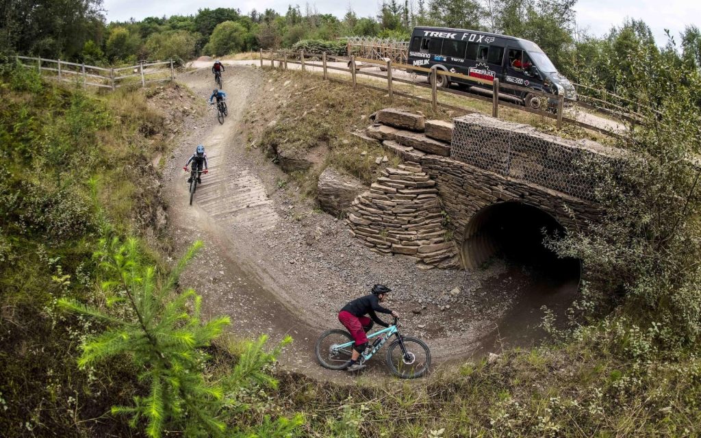 Mountain biker riding through the purpose-built trail network at BikePark Wales