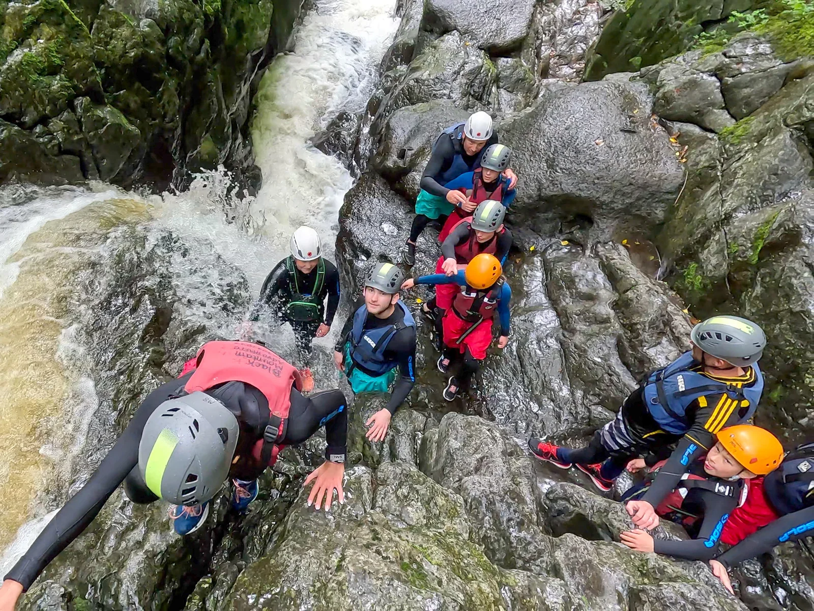 Group tackling a waterfall on a guided gorge adventure with Black Mountain Adventure