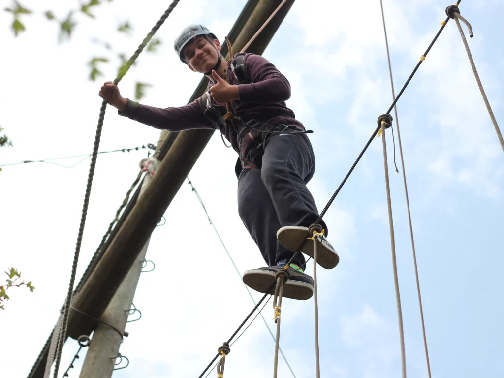 Participant on a high-ropes obstacle at Black Mountain Adventure