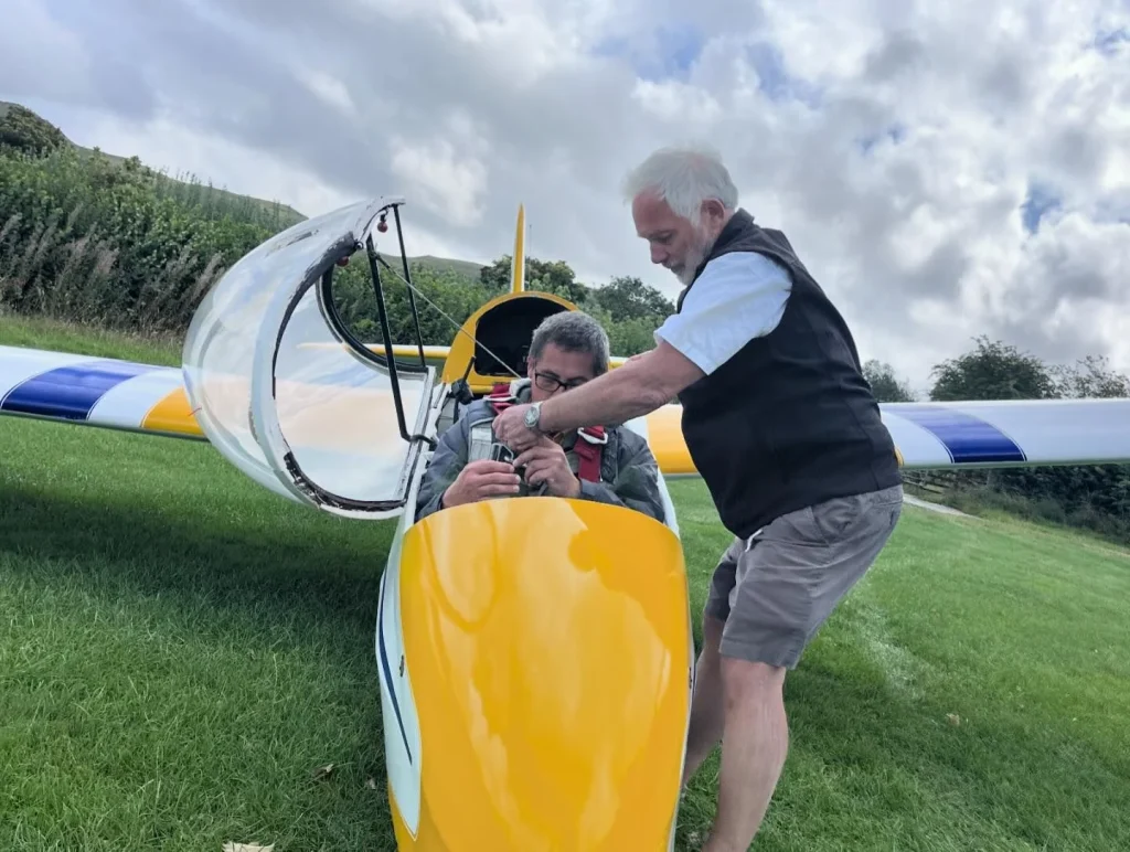 Instructor helping a participant prepare for a flight at Black Mountains Gliding Club