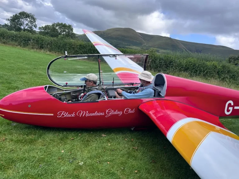 Red glider ready on the grass at Black Mountains Gliding Club