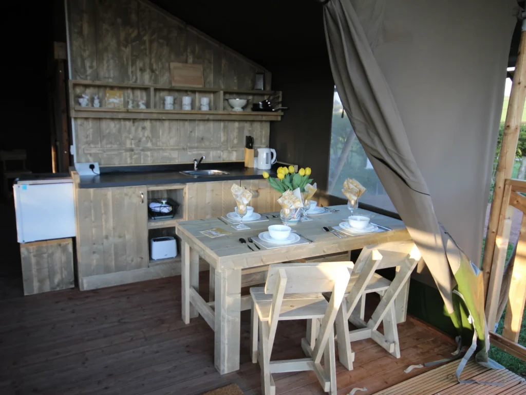Covered kitchen and dining area inside the family safari tent at Bryndu