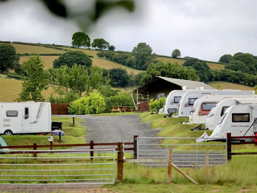 Caravans on green touring pitches at Bryndu Caravan and Camping Park