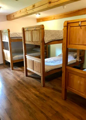 Timber bunk beds inside Coed Owen Bunkhouse