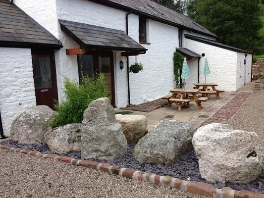 White stone Coed Owen Bunkhouse with outdoor seating