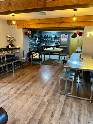 Spacious kitchen and communal dining area at Coed Owen Bunkhouse