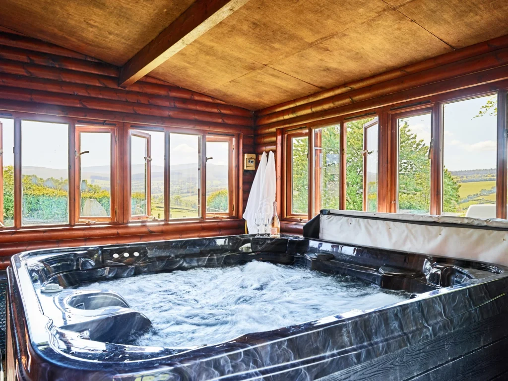 Covered hot tub with countryside views at Crai Valley Eco Lodge in the Dark Sky Collection