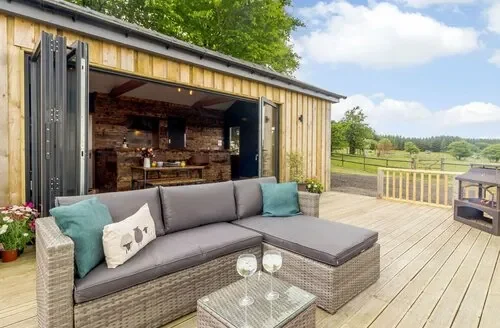 Outdoor seating on a countryside deck from Dog Friendly Cottages