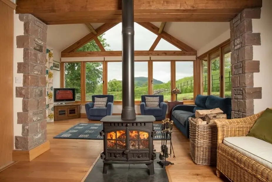 Light-filled living room with wood-burning stove from Dog Friendly Cottages
