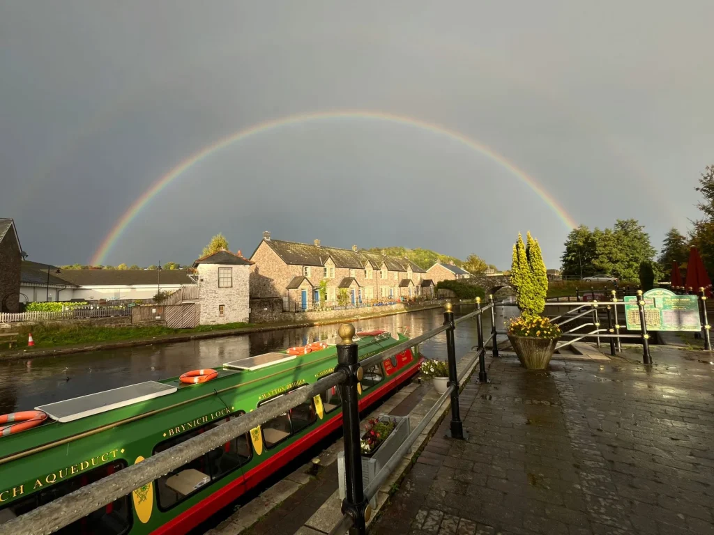 Rainbow over the boats and buildings at Brecon Canal Basin