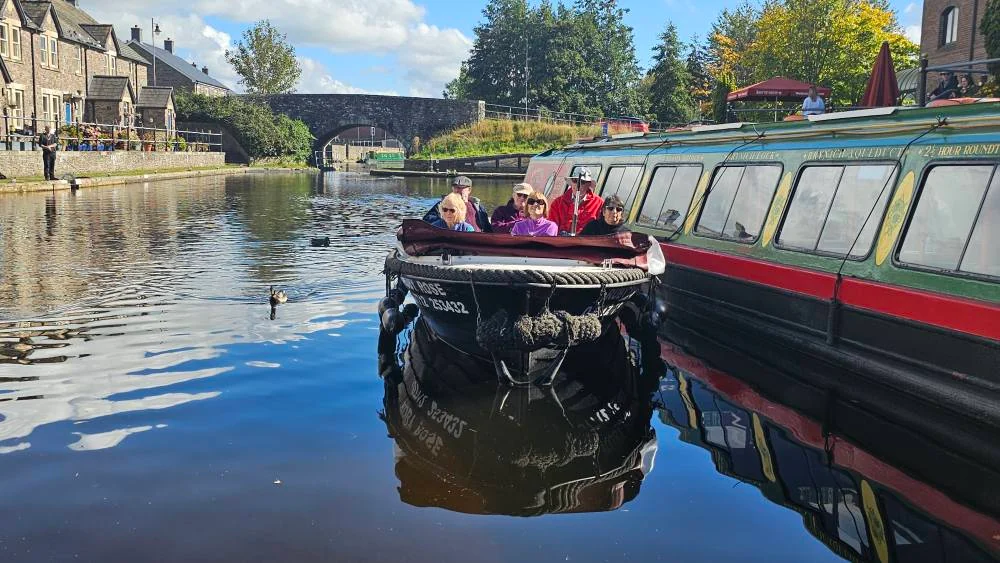 Passengers aboard a Dragonfly self-drive day boat in Brecon Canal Basin
