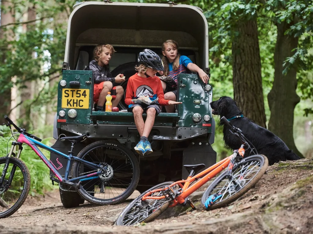 Family group with bikes on a woodland cycling outing with Drover Cycles