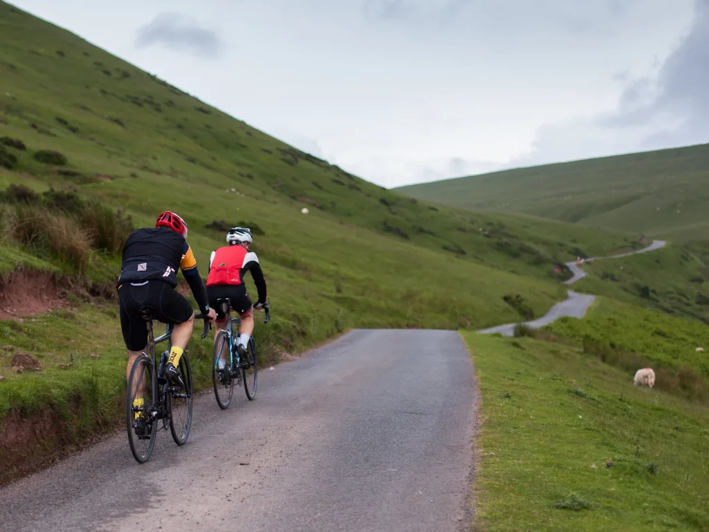 Cyclists riding along a quiet mountain road near Hay-on-Wye