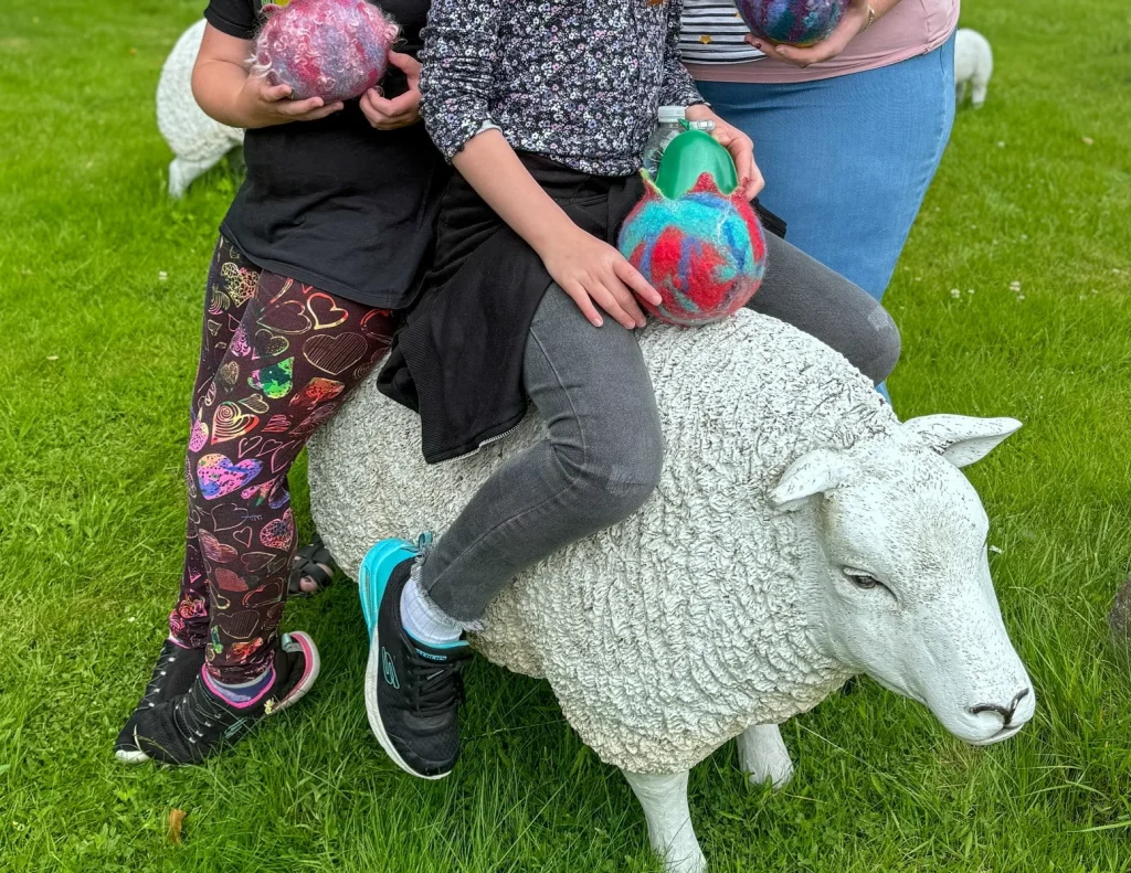 Adults and children enjoying colourful felt creations at a Fabulous Feltings session