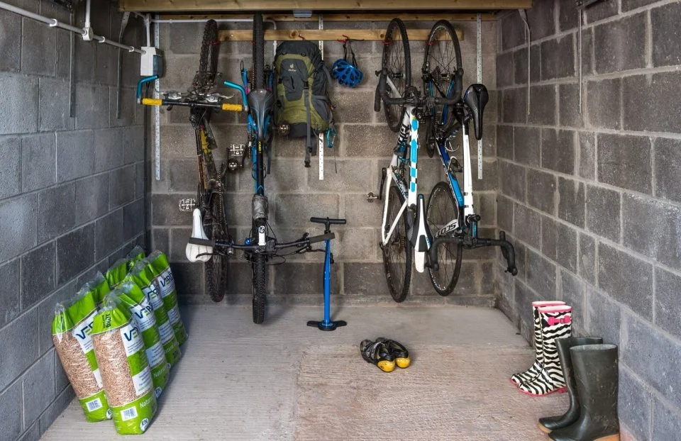 Locked bike storage and outdoor equipment space at Glanpant Bach