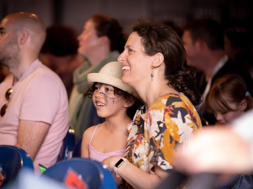 Adults and children enjoying a live event together at Hay Festival