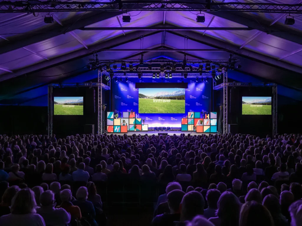 Large audience watching a speaker on the main stage at Hay Festival