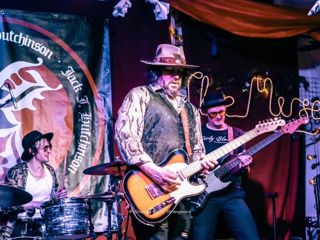 Electric guitarist performing at a Mid Wales Rhythm and Blues Club event