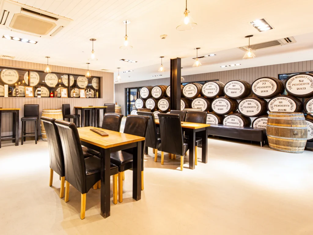 Bright tasting room with barrel display at Penderyn Distillery