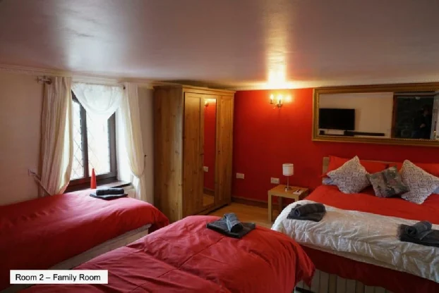 Family bedroom with red walls at Pentre Riding Stables accommodation