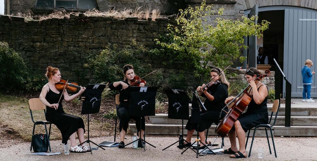 A string quartet performing outside Hay Castle
