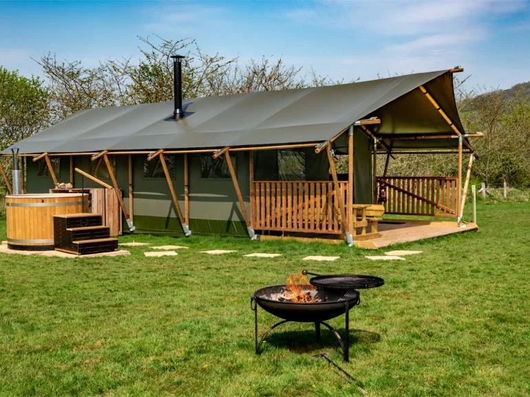 Canvas safari lodge with veranda and fire pit in the Sugar & Loaf collection
