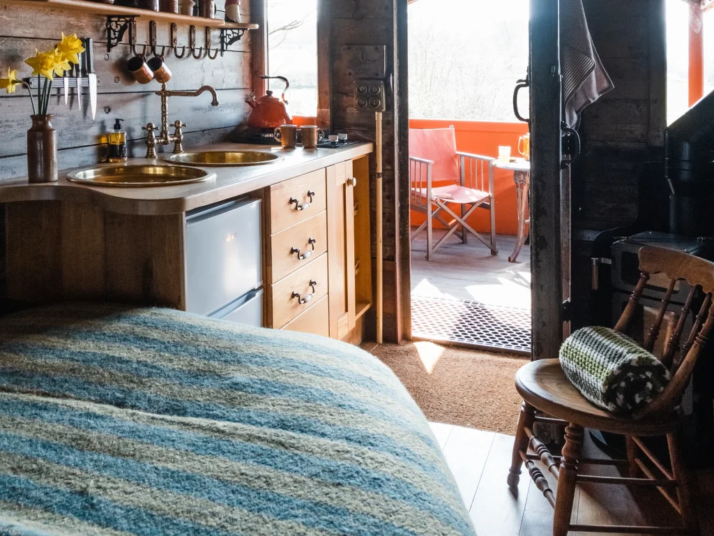 Cosy converted railway carriage interior at Toad and Snail Glamping