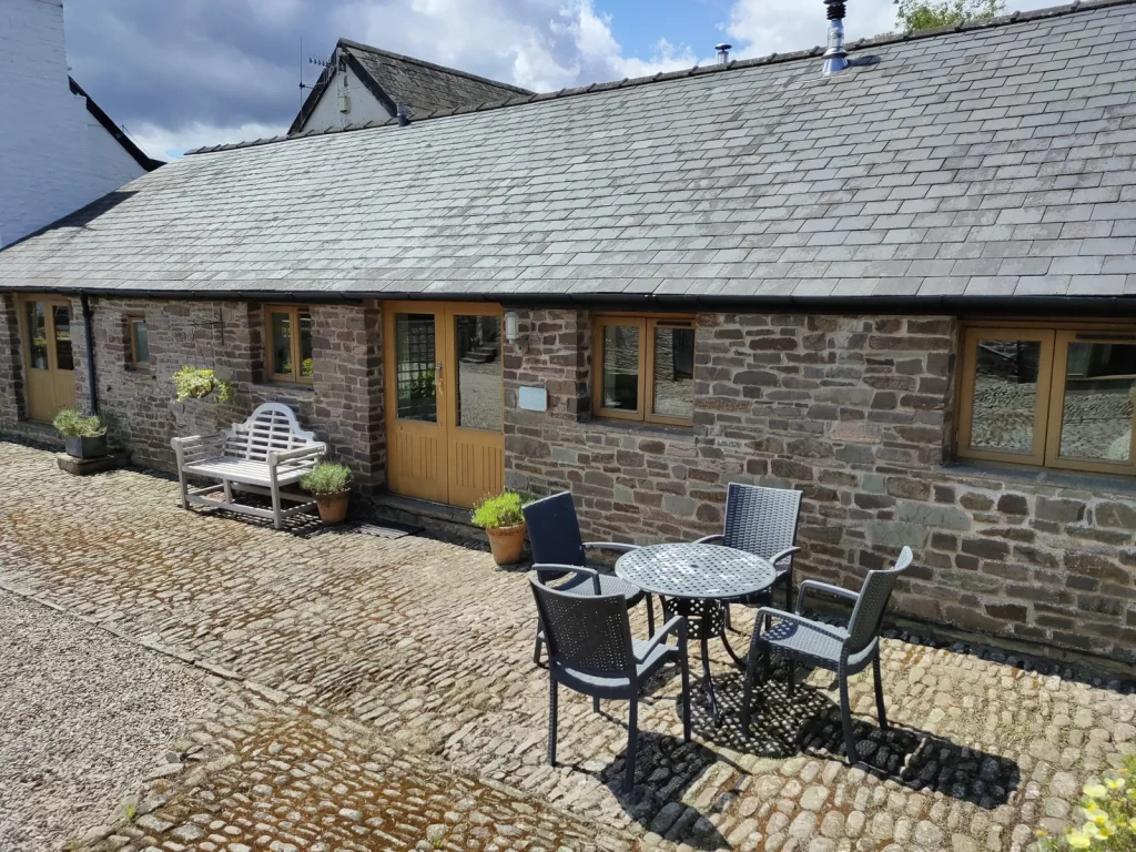 Stone holiday cottages around the courtyard at Ty Newydd Holidays near Llanfrynach