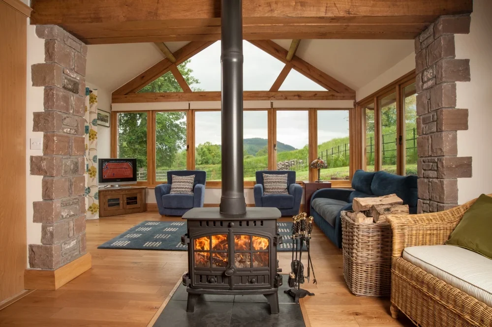 Bright country-cottage sunroom with wood-burning stove from Wales Cottage Holidays