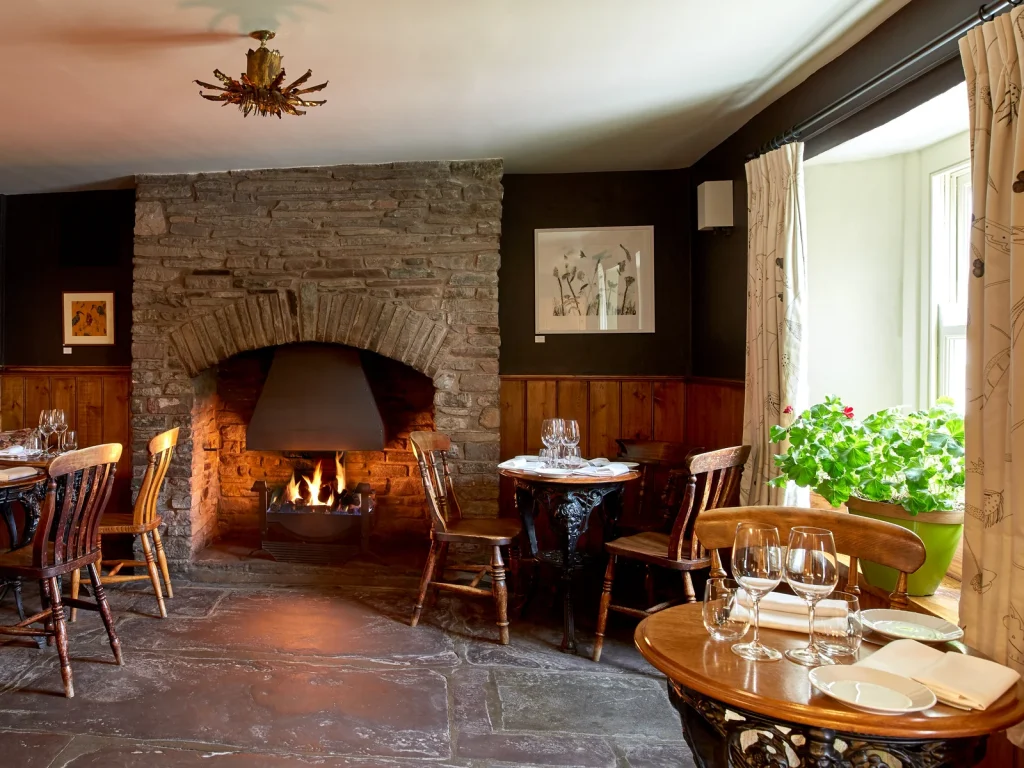 Warm wood-panelled dining room at The Walnut Tree restaurant