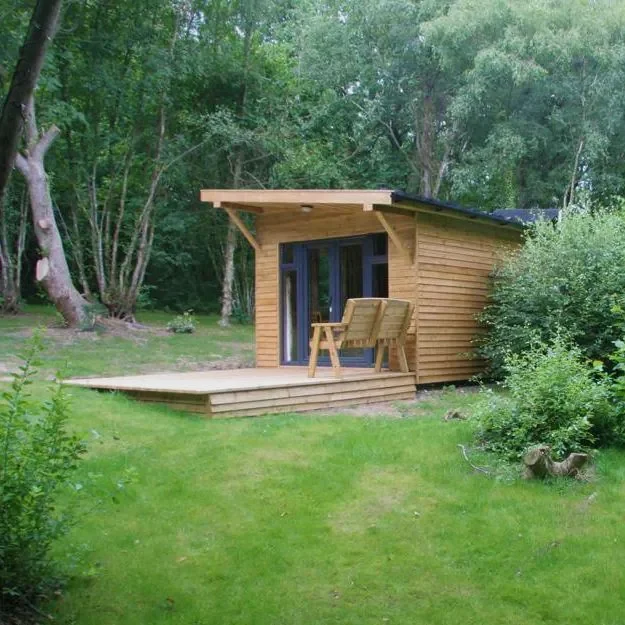 Grouse glamping cabin among the trees at Woodland Park Glamping near Brecon
