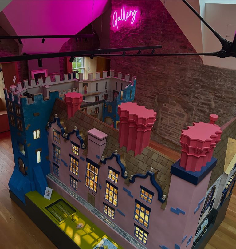 The Contraption interactive model of Hay Castle lit in pink and blue inside the castle gallery